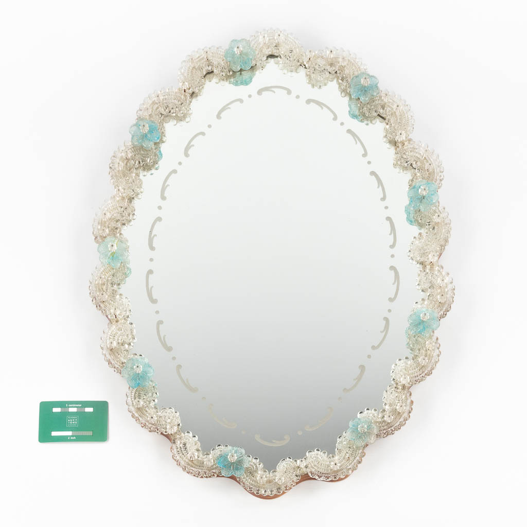 A small Venetian glass wall-mounted mirror, decorated with blue flowers. (W:45 x H:60 cm)