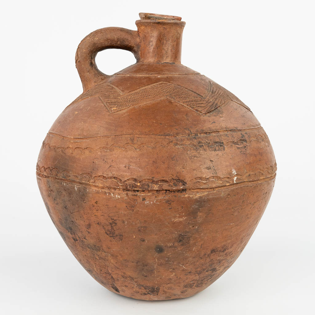 An antique jug with the original stopper made of terracotta finished with sgraffito decor. (H:32cm)