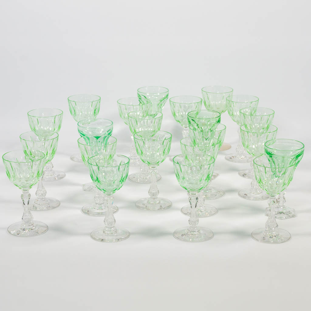 A collection of 22 crystal 'uranium glasses': a set of 18 and 4 pieces. Glowing bright green under UV light