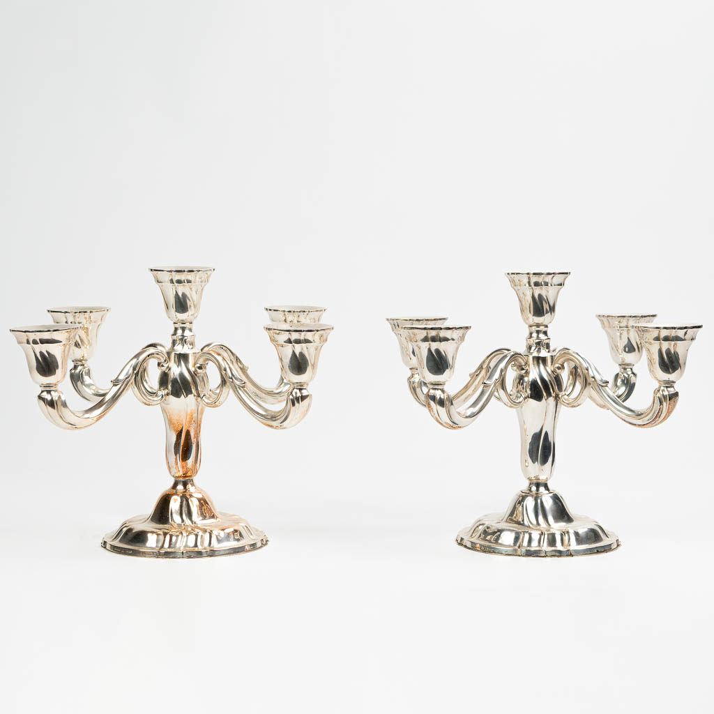 A pair of candelabra made of silver and marked 0,835. Made in Germany.