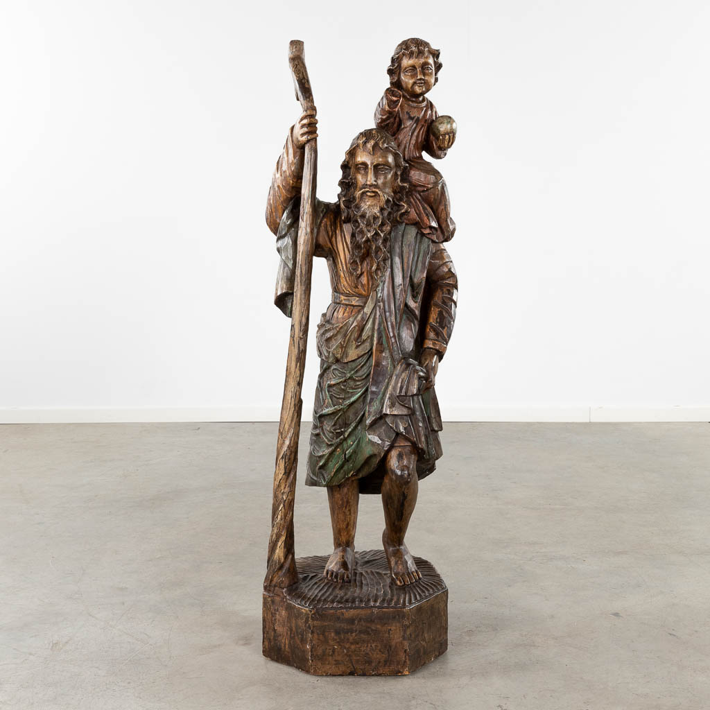 A large wood-sculptured figurine of Saint Christopher. Circa 1900. (D:35 x W:40 x H:127 cm)