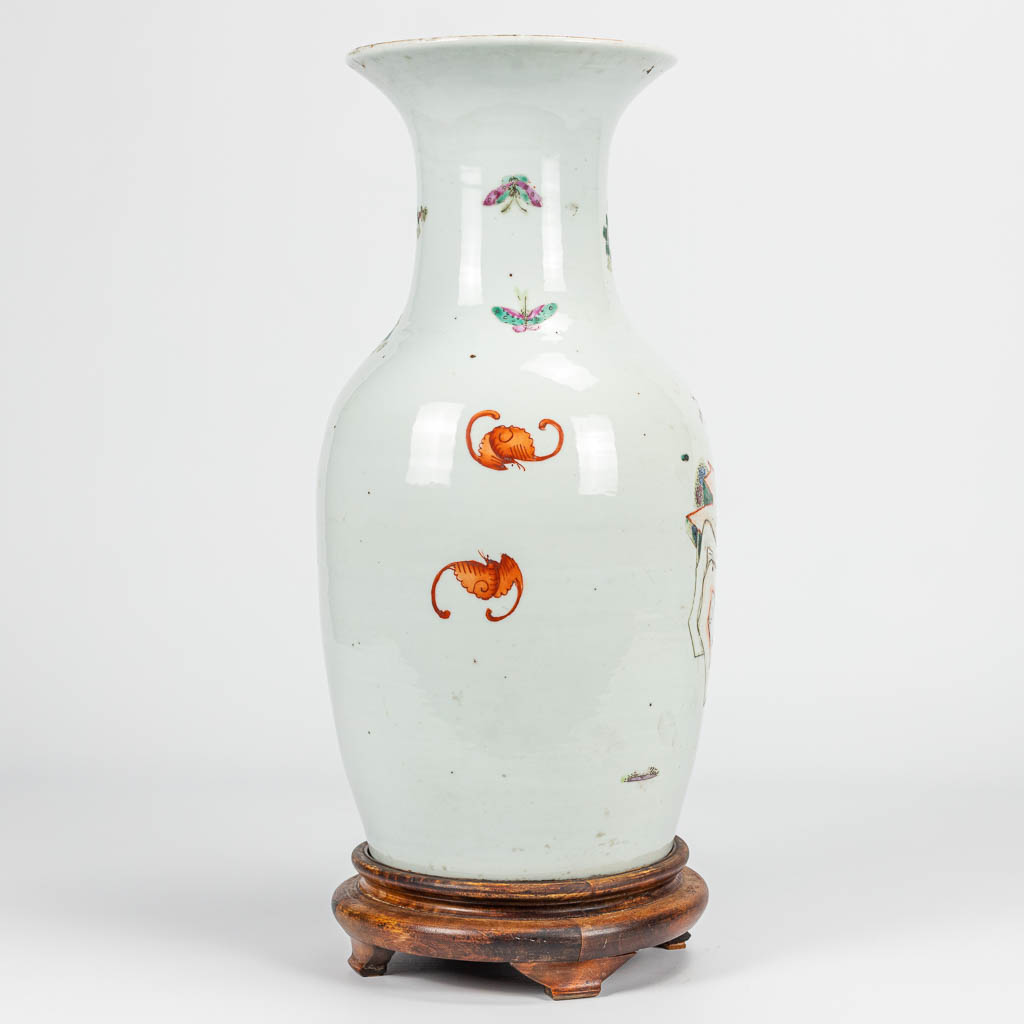 A vase made of Chinese porcelain decorated with ladies, children and bats