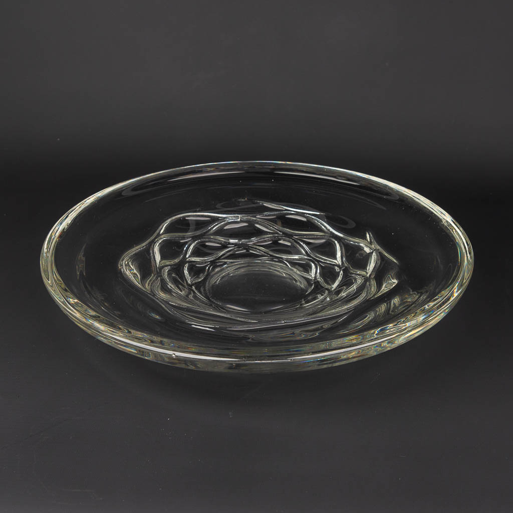 A large bowl made of crystal and marked 