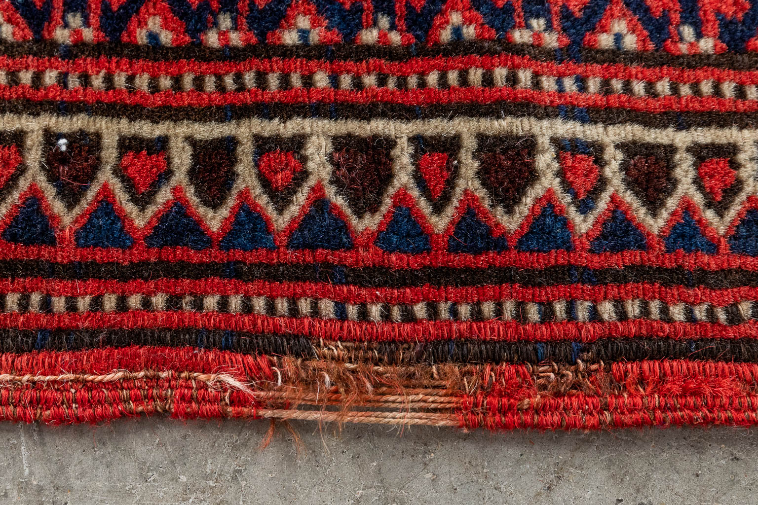 An Oriental hand-made carpet. (D:226 x W:119 cm)