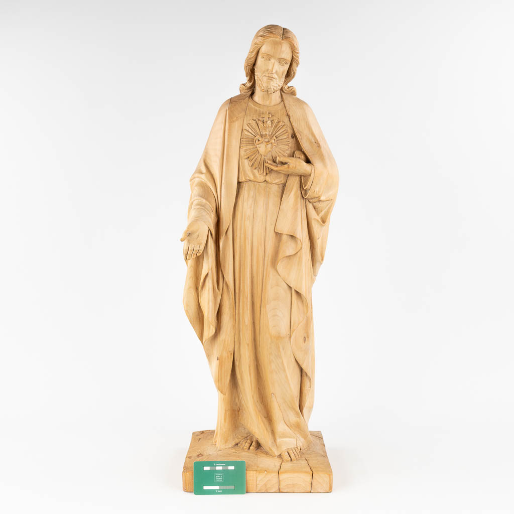 A wood-sculptured figurine of Jesus Christ with a Sacred Heart. The first half of the 20th century. (L: 22 x W: 25 x H: 77 cm)