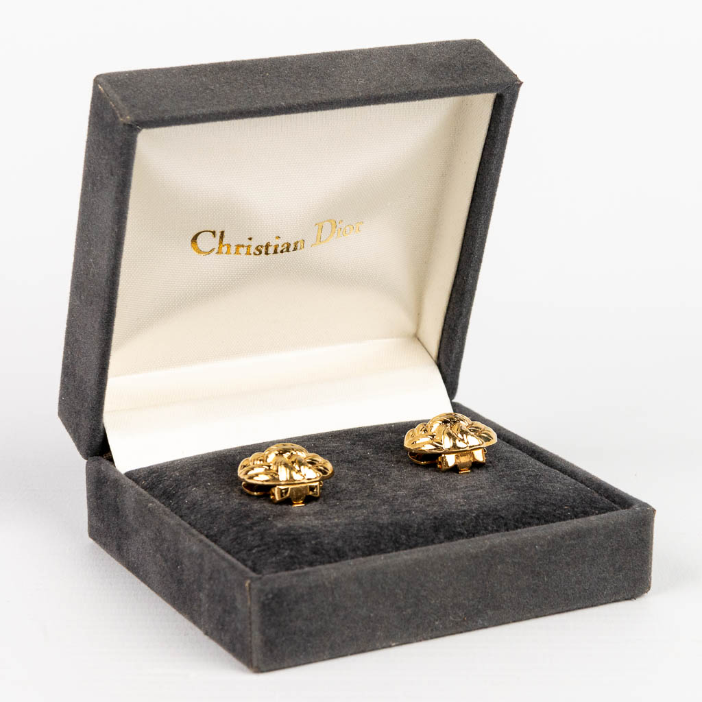 A pair of button covers made by Christian Dior, gold-plated. 
