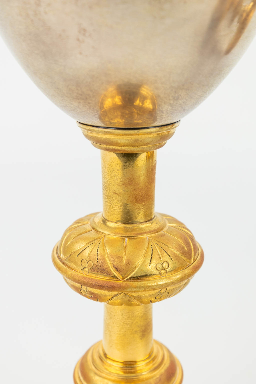 A collection of 4 large ciboria and a chalice made of silver and gold plated metal. 