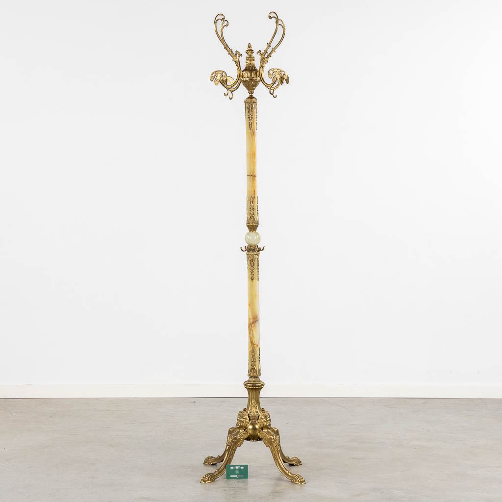 A coathanger, onyx and brass. Circa 1950. (L:40 x W:40 x H:180 cm)