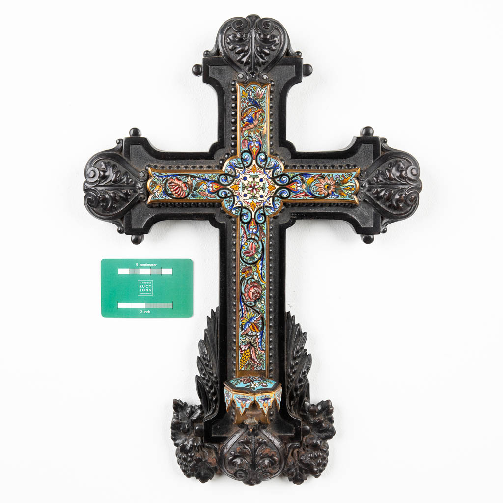 A crucifix finished with champleve, with a holy water font and mounted in an ebony cross. (H:43cm)