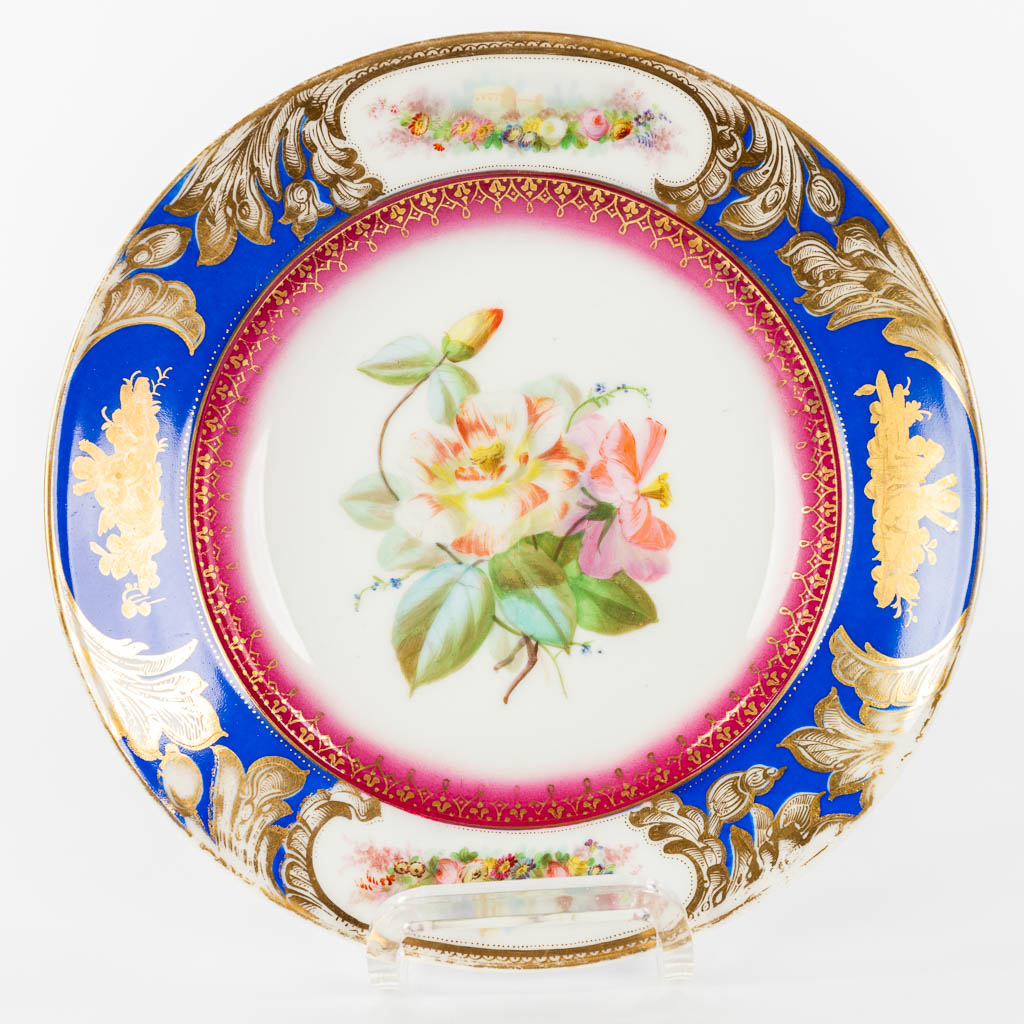 A collection of 4 plates made of porcelain and decorated with hand-painted flowers. 