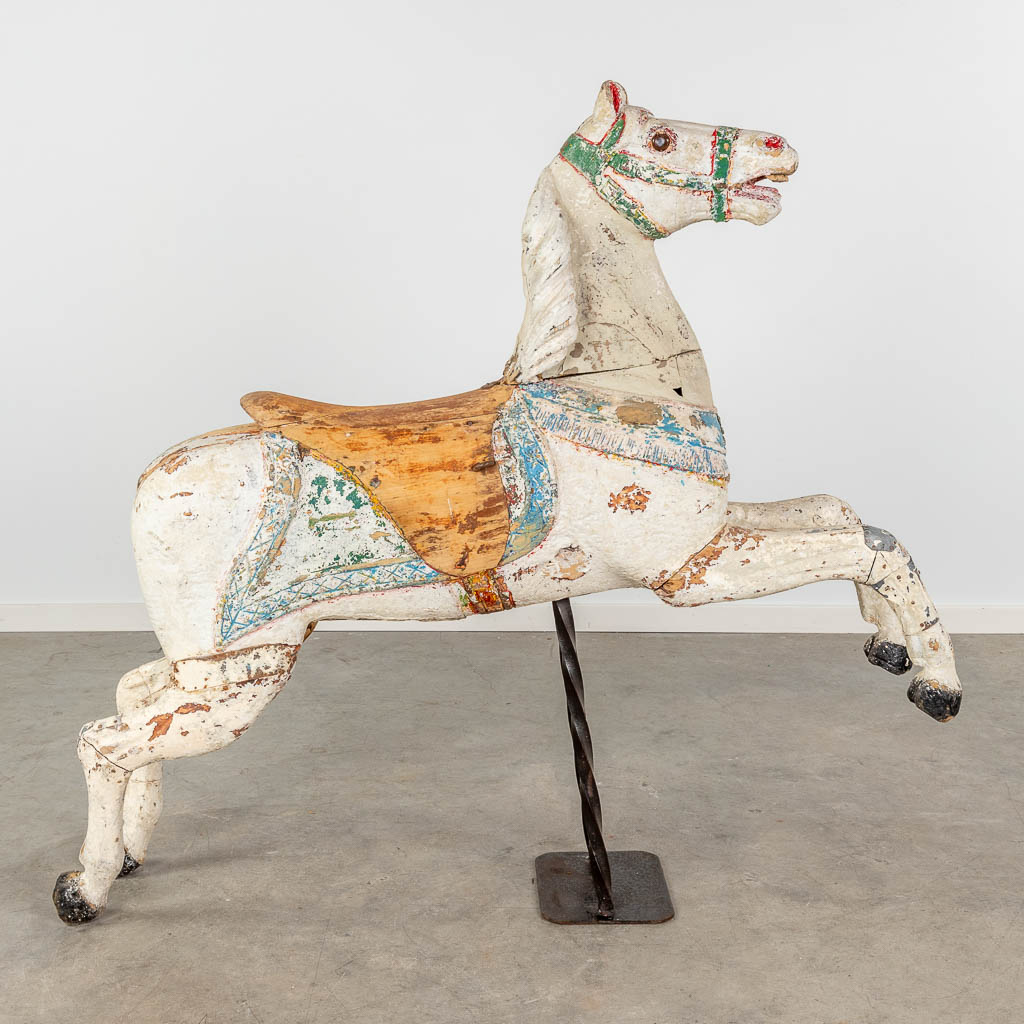 An antique horse for a Merry Go Round, made of sculptured wood, with original polychrome (D:32 x W:130 x H:240 cm)