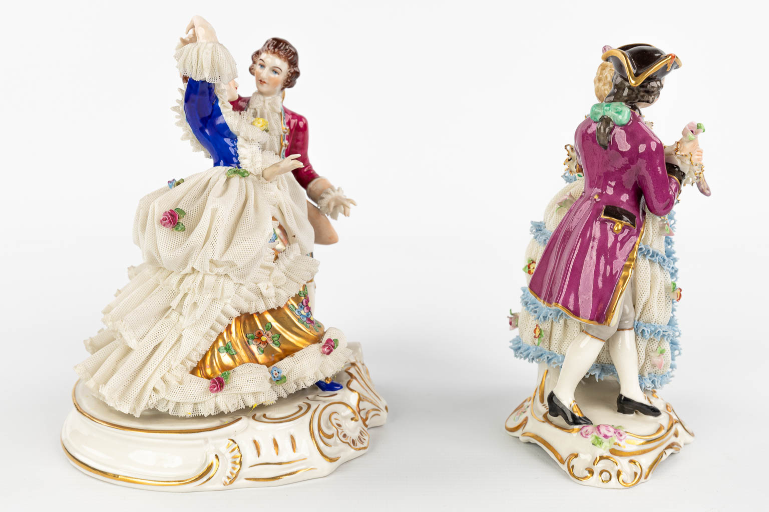 A pair of porcelain figurines with a lace dress. Made in Germany and marked Dresden. (H:19cm)