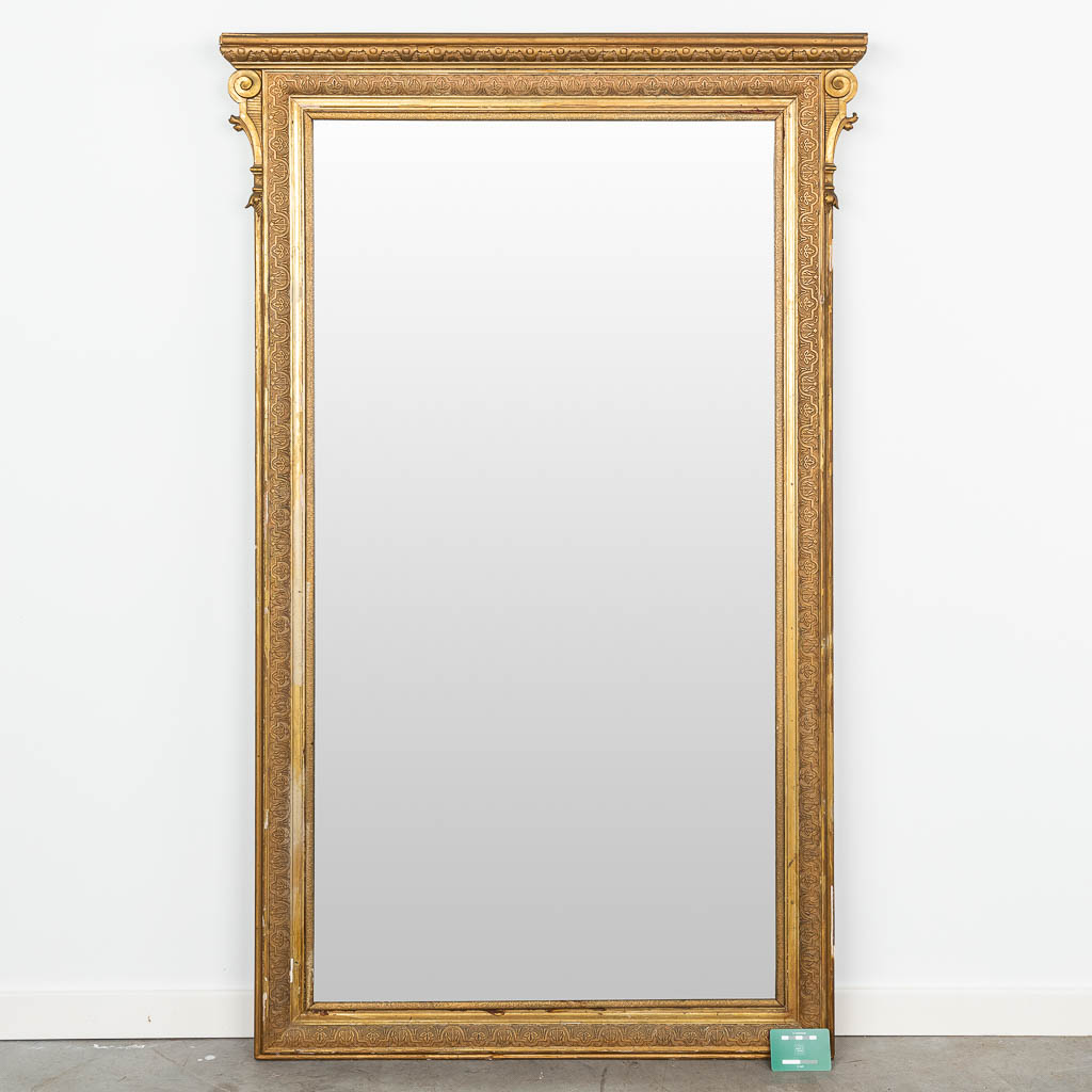 A mirror made of wood and finished with gilt stucco. (H:148cm)