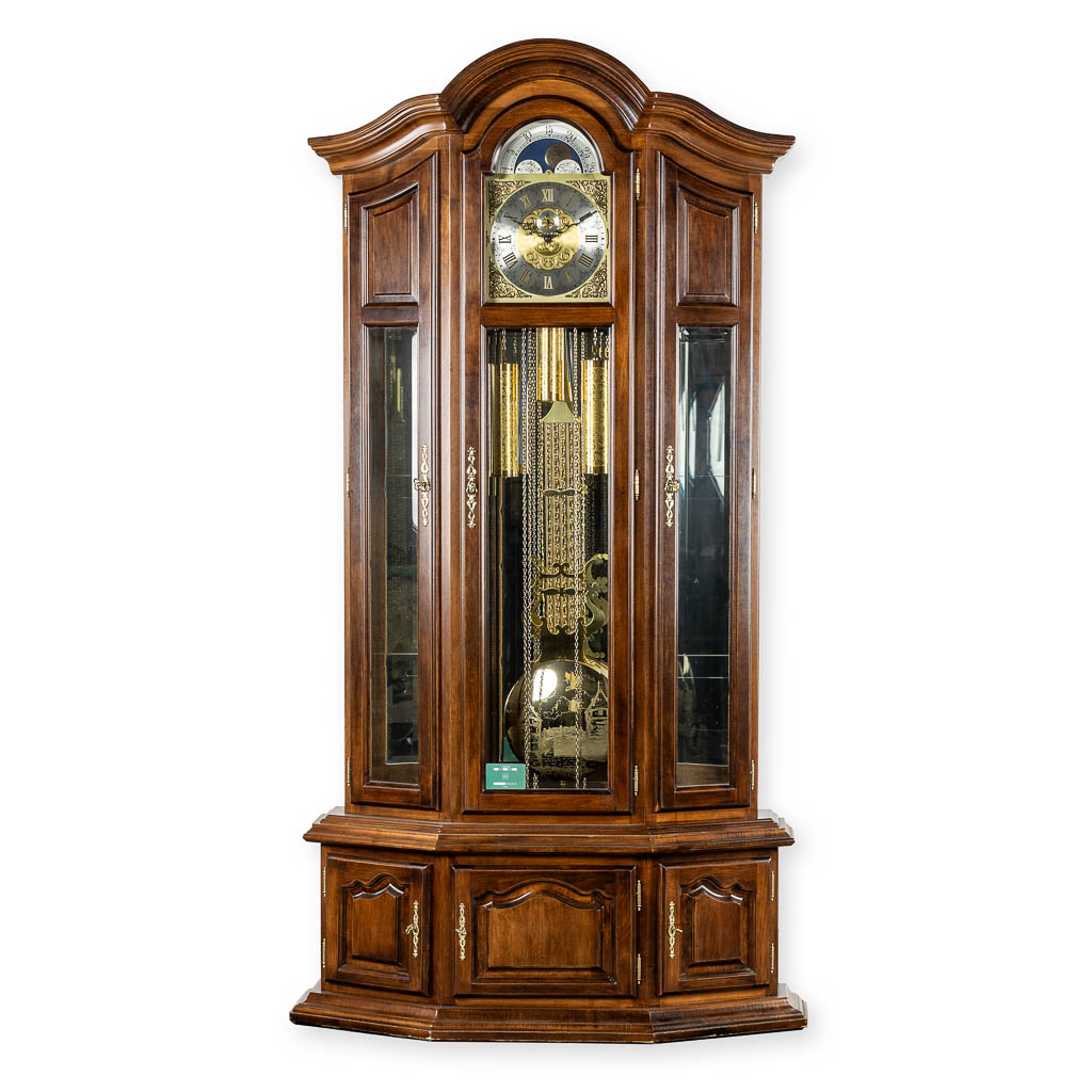 A decorative standing clock, with decorated weights. (L:40 x W:106 x H:214 cm)