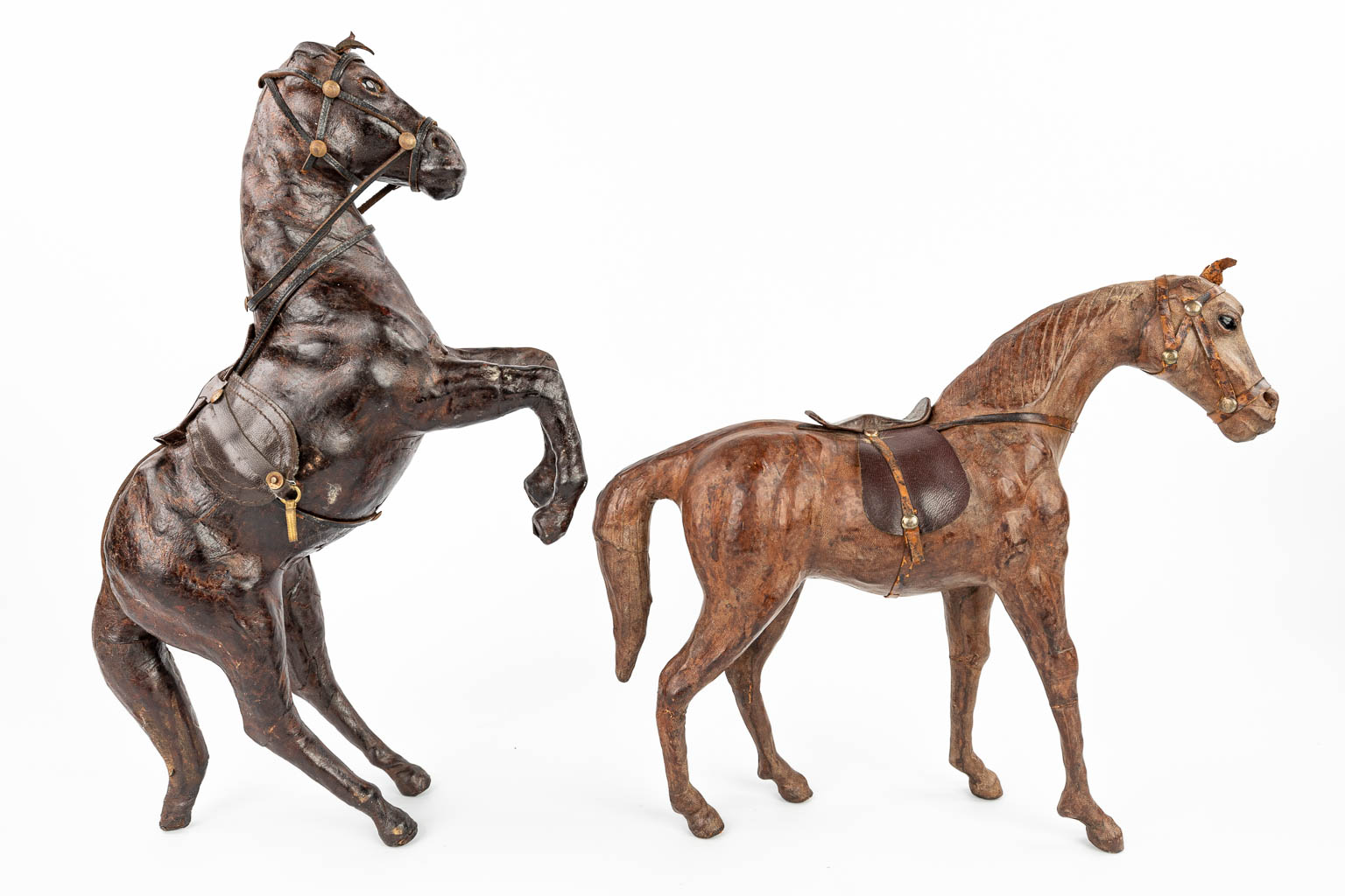 A collection of 15 horses made of Papier Maché and finished with leather. (H:30cm)