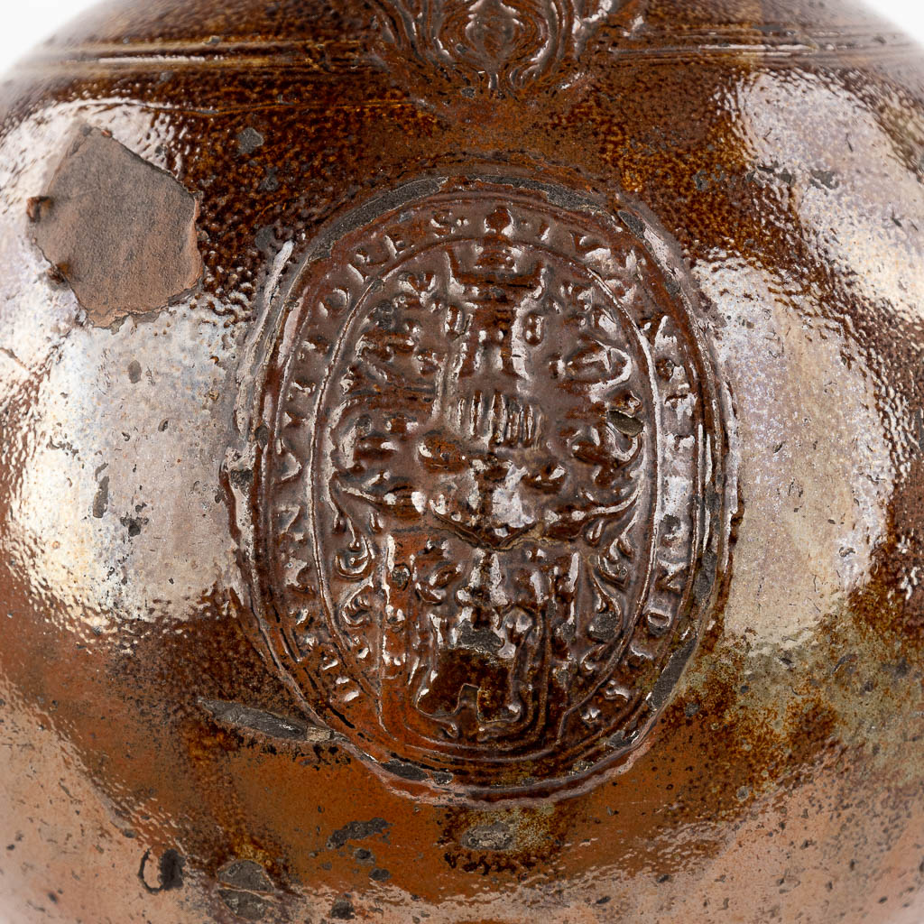 An antique Bartmann Jug, grès stoneware, decorated with 3 cartouches. 17th C. (H: 50 x D: 33 cm)