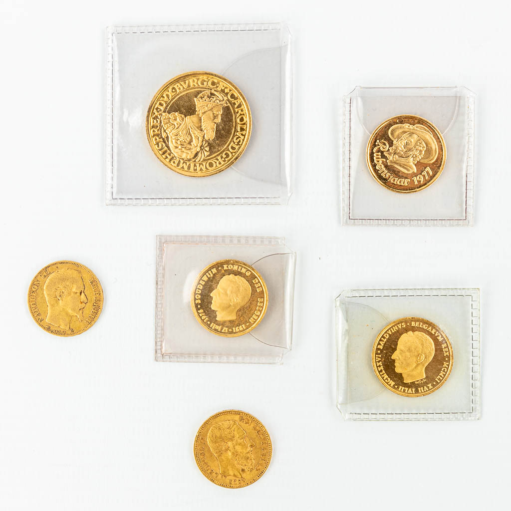 A collection of 6 coins made of gold. 