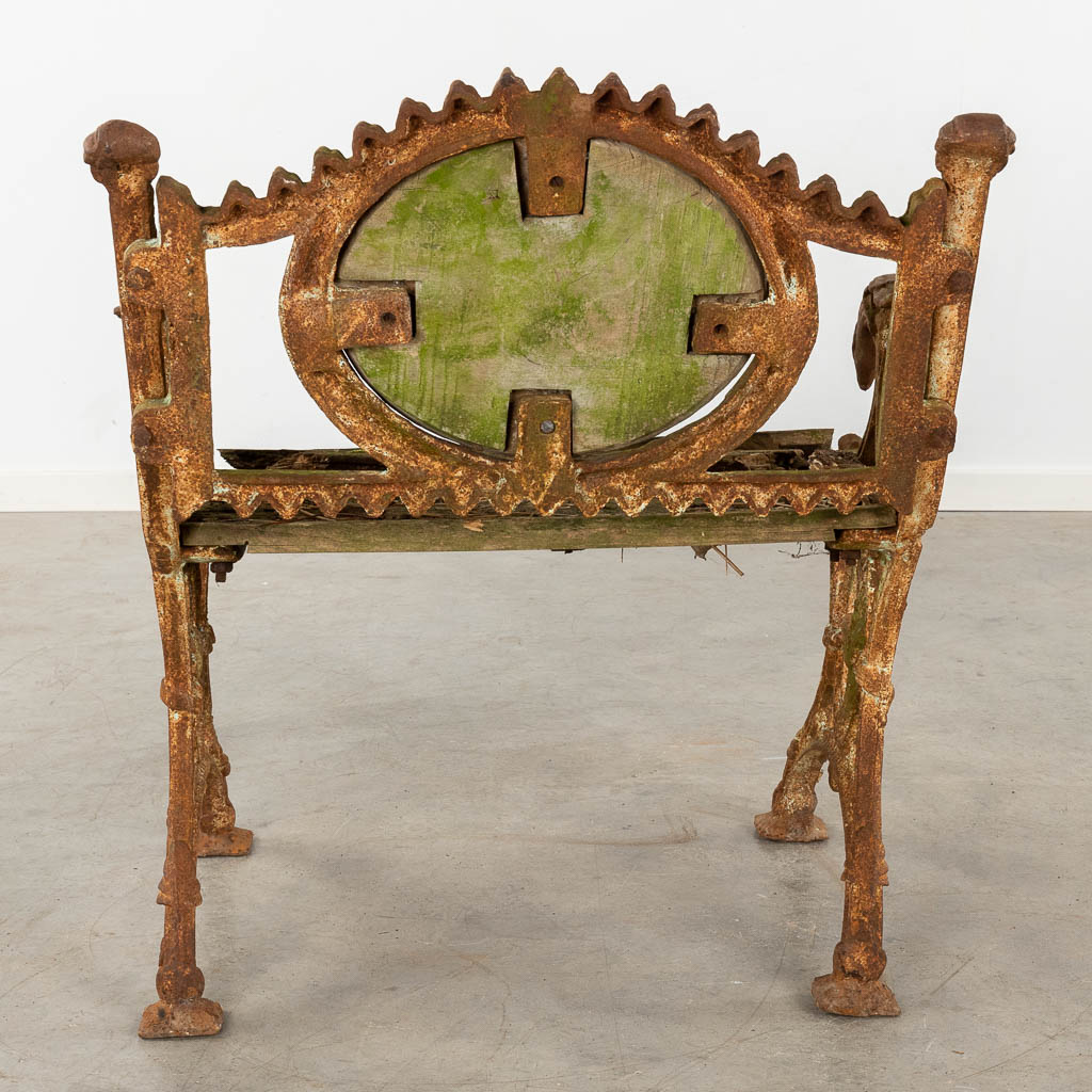 An antique garden bench, cast iron and decorated with birds and butterflies. (D:55 x W:72 x H:81 cm)