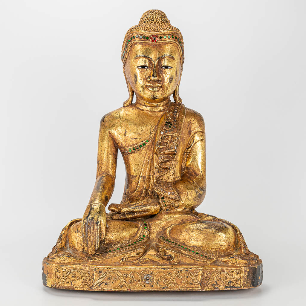 An oriental wood sculptured and gilt Buddha. 