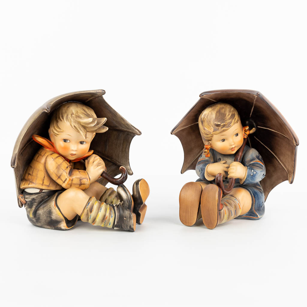 Een collectie van 2 beeldjes van kinderen met paraplu gemaakt door Hummel (H:19cm)
