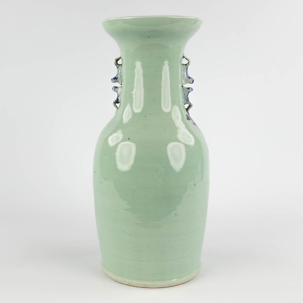 A Chinese celadon vase with blue-white decor of flora. 19th/20th C (H:42 x D:19 cm)