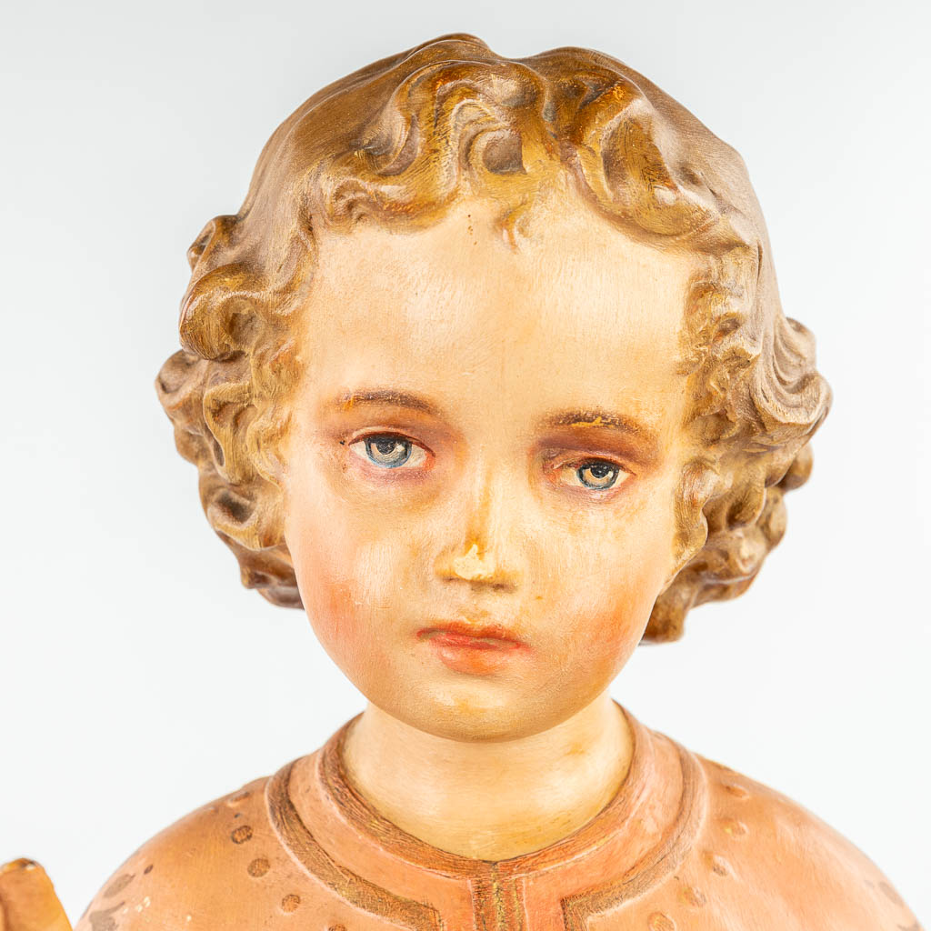 A statue made of patinated plaster 'Boy Jesus with Sacred Heart'. 