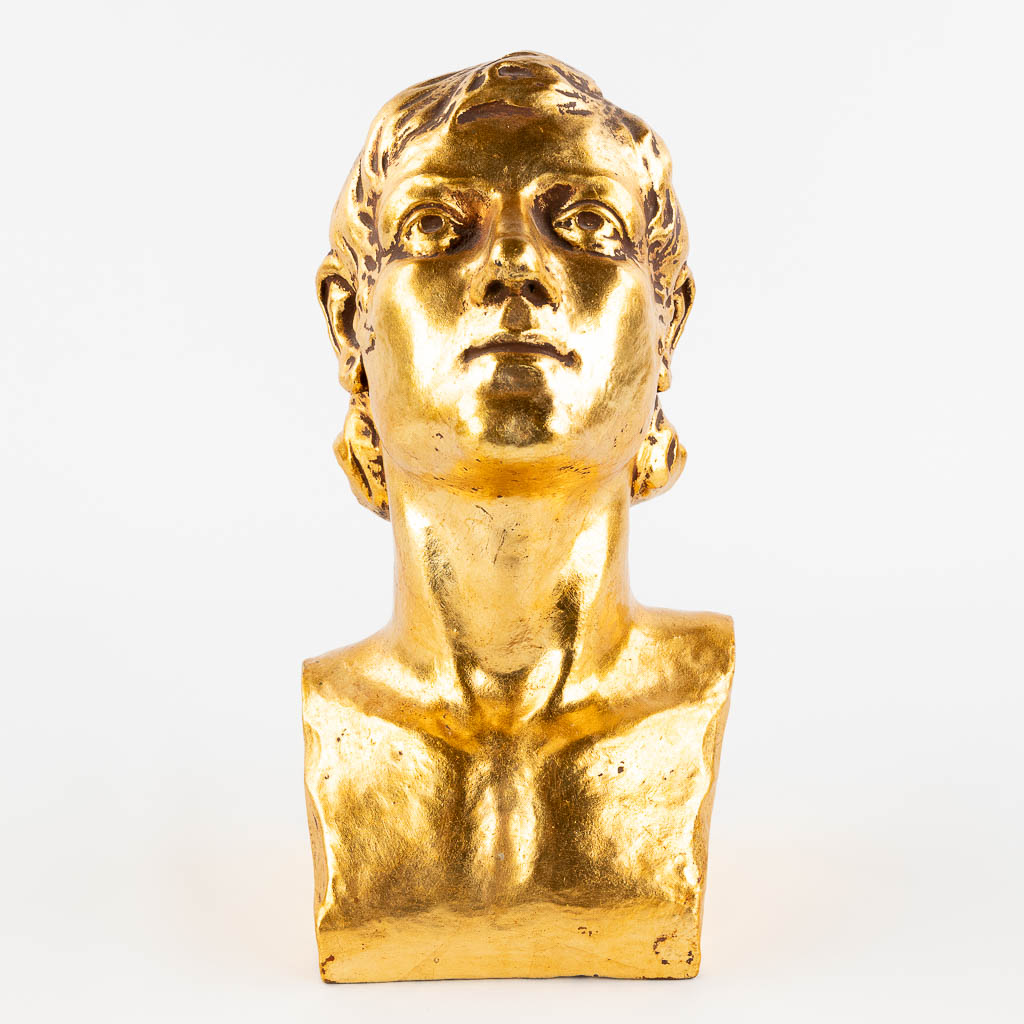 Een goudgeglazuurde terracotta buste gemerkt G. De La Soit. 1931. (L: 17 x W: 14,5 x H: 28 cm)