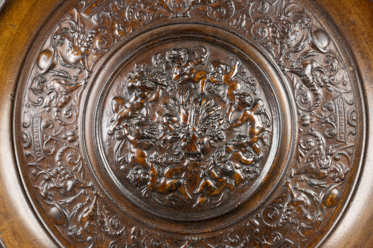 A large and decorative plate made of cast iron. 