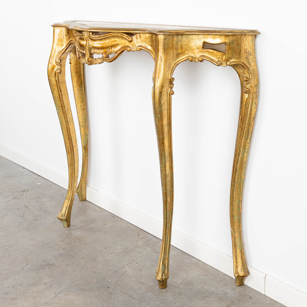 A gilt console table made of wood with stucco. (H:86cm)