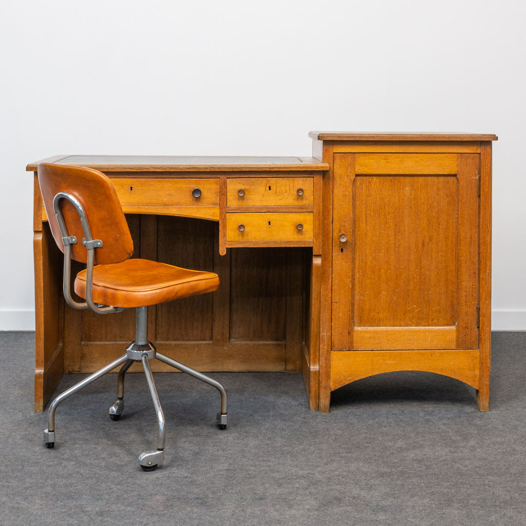 An antique small working desk with original industrial chair. First half of the 20th century. 