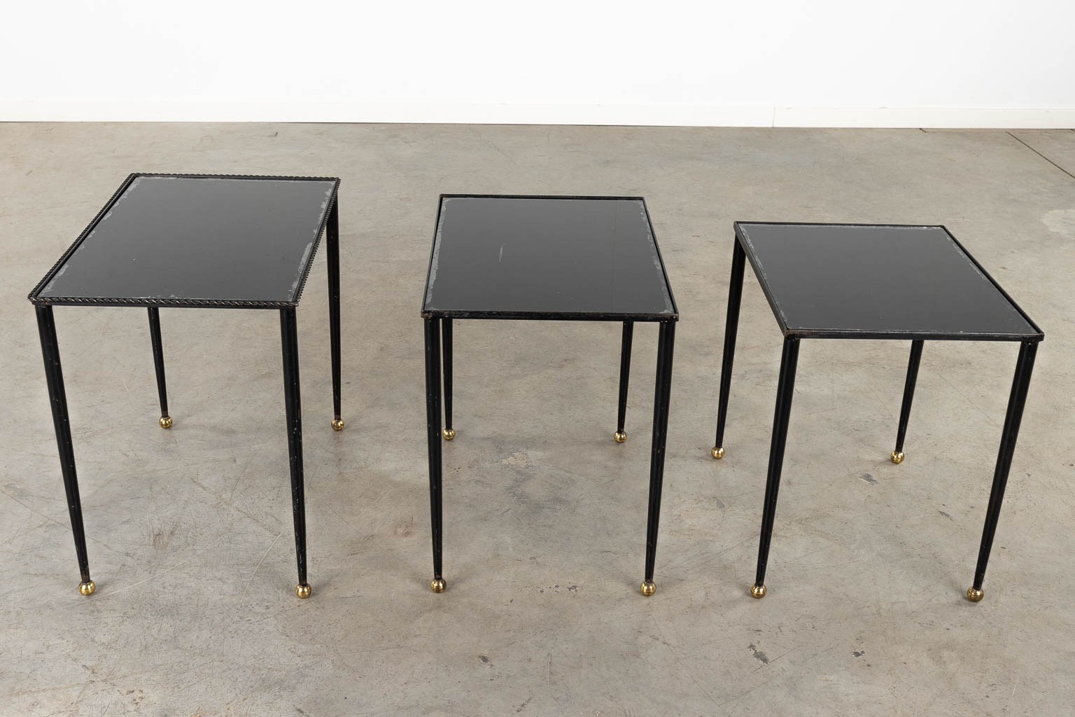 A set of Nesting tables, metal and black tinted glass. 20th C. (D:56 x W:37 x H:50 cm)