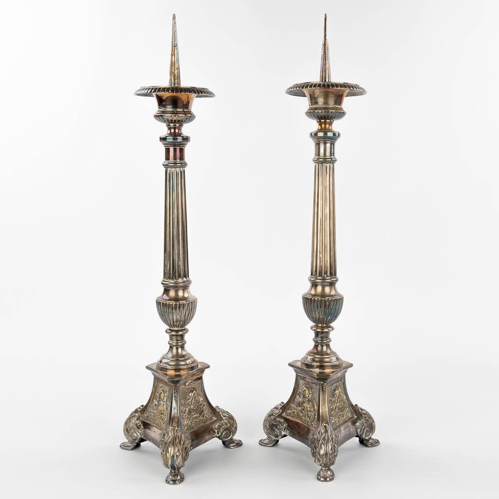 A pair of silver-plated candlesticks decorated with images of holy figurines. (H:59cm)