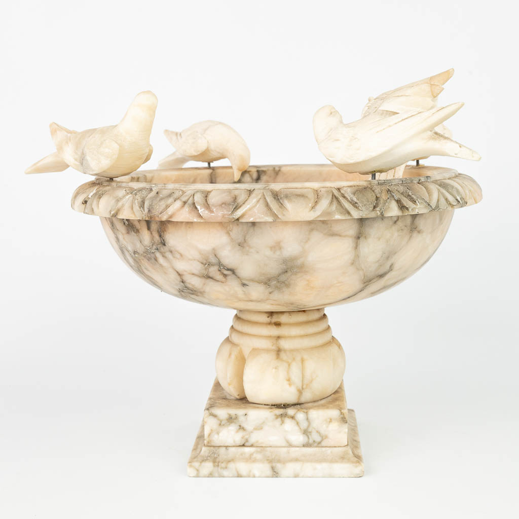 A drinking bowl made of alabaster with figurines of birds. (H:29cm)