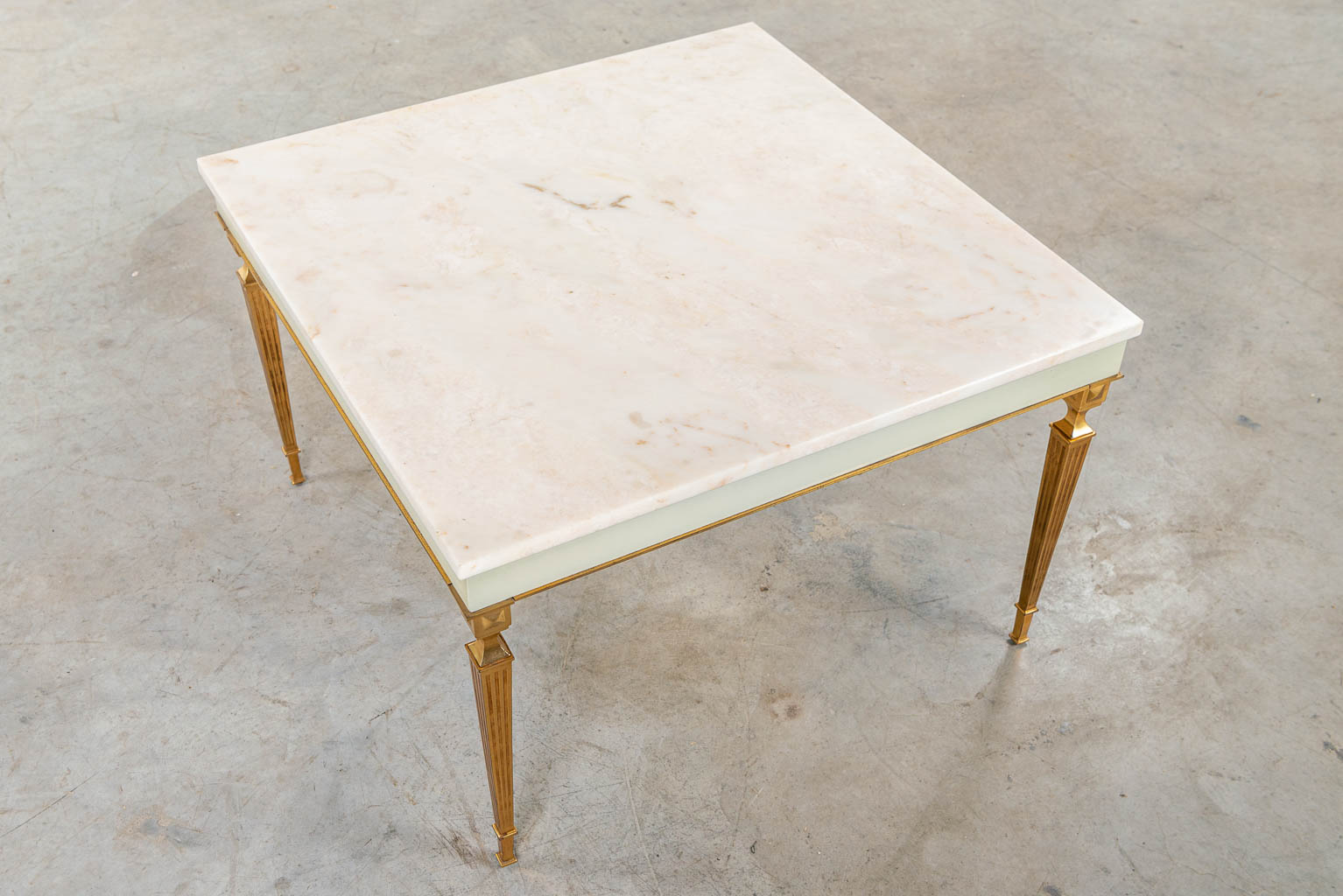 A coffee table made in Hollywood Regency style, brass and marble. (H:48cm)