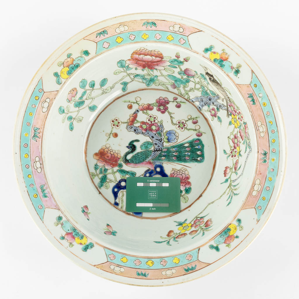 A large Chinese bowl, Famille Rose decorated with a Peacock and blossoms. 19th century. (H:12,5 x D:37 cm)