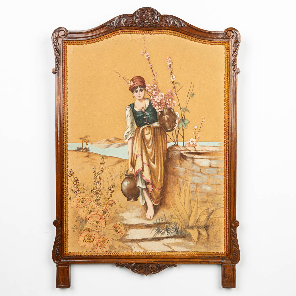 A fireplace screen made of wood and finished with a painted and embroidered water carrier. (H:91cm)