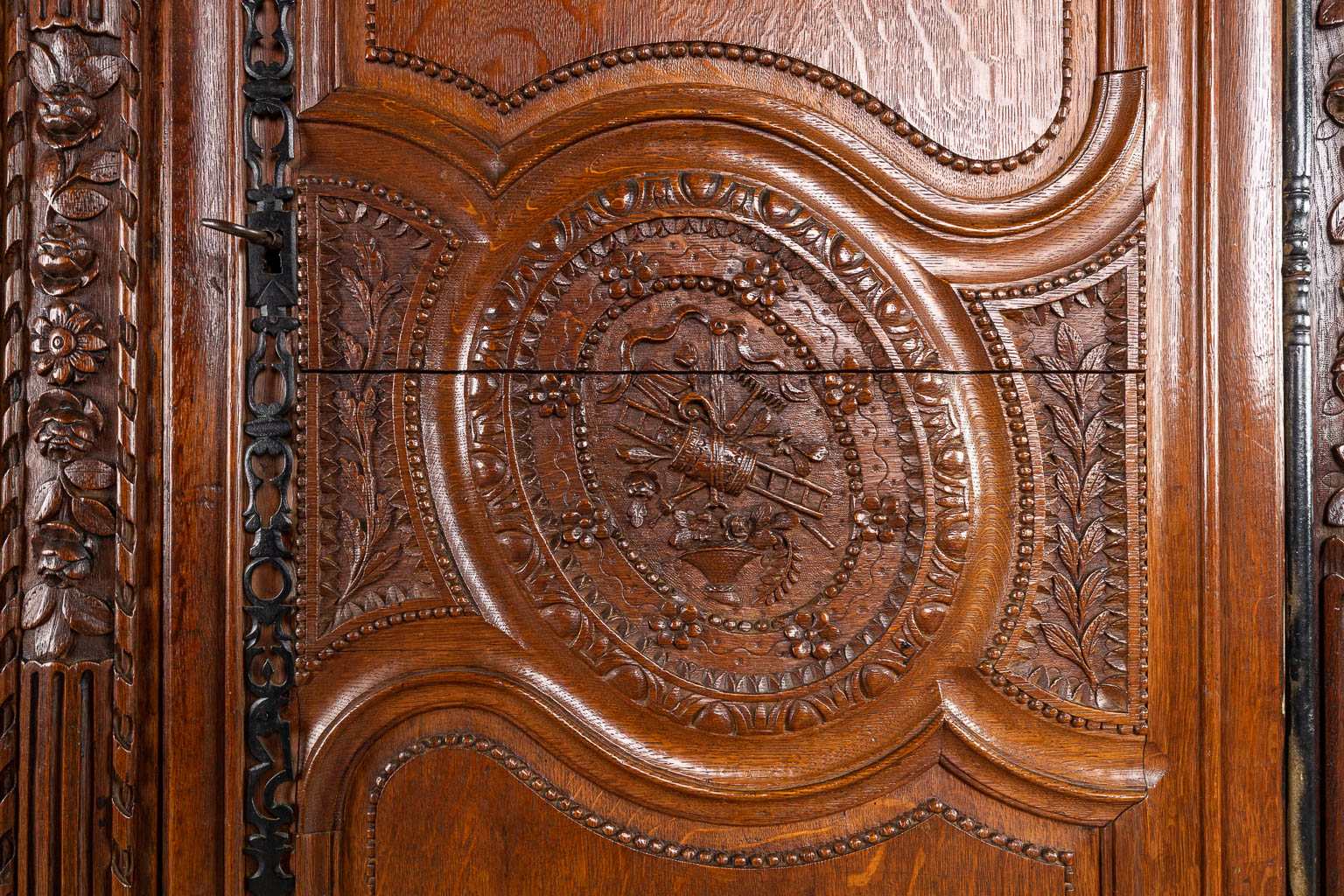 A richly sculptured and antique Normandy high cabinet, Armoire. France, 18th C.