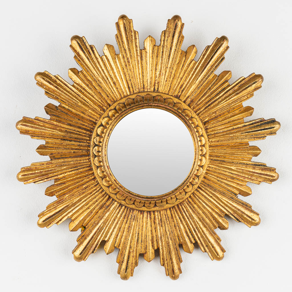 A collection of 2 mid-century sunburst mirror