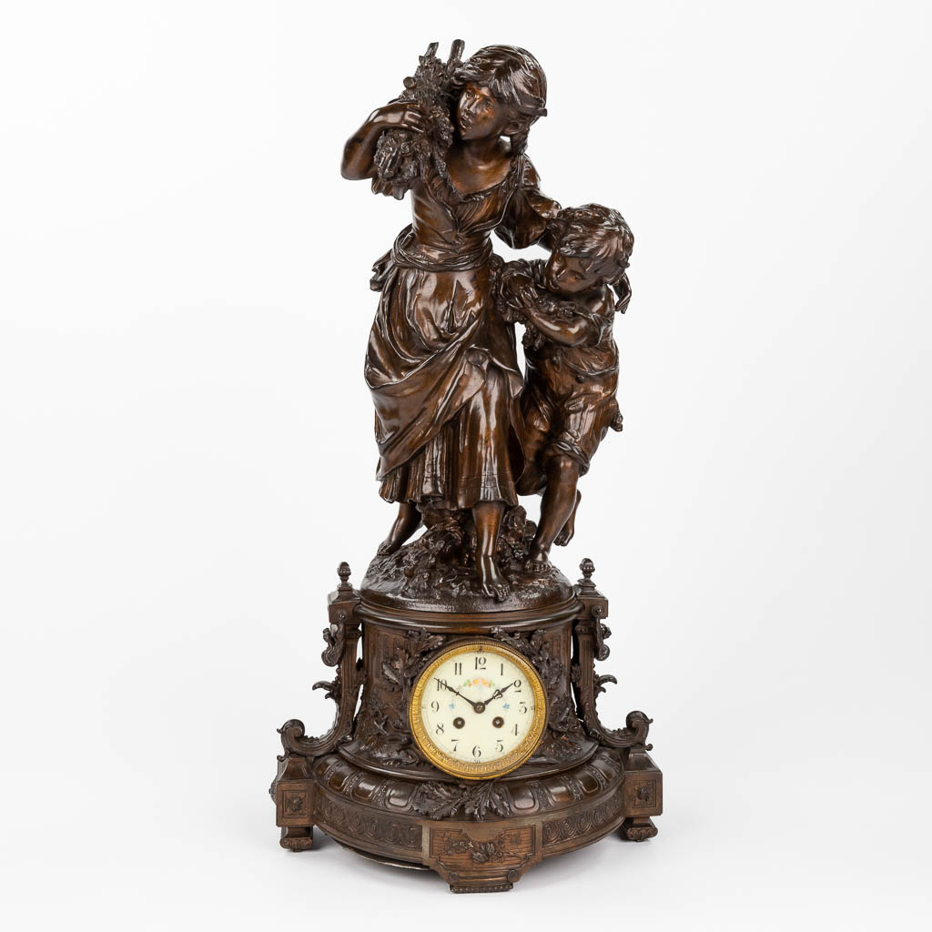 Auguste MOREAU (1834-1917) 'Mother and child with a harvest' a mantle clock, patinated spelter. (D:27 x W:40 x H:81 cm)