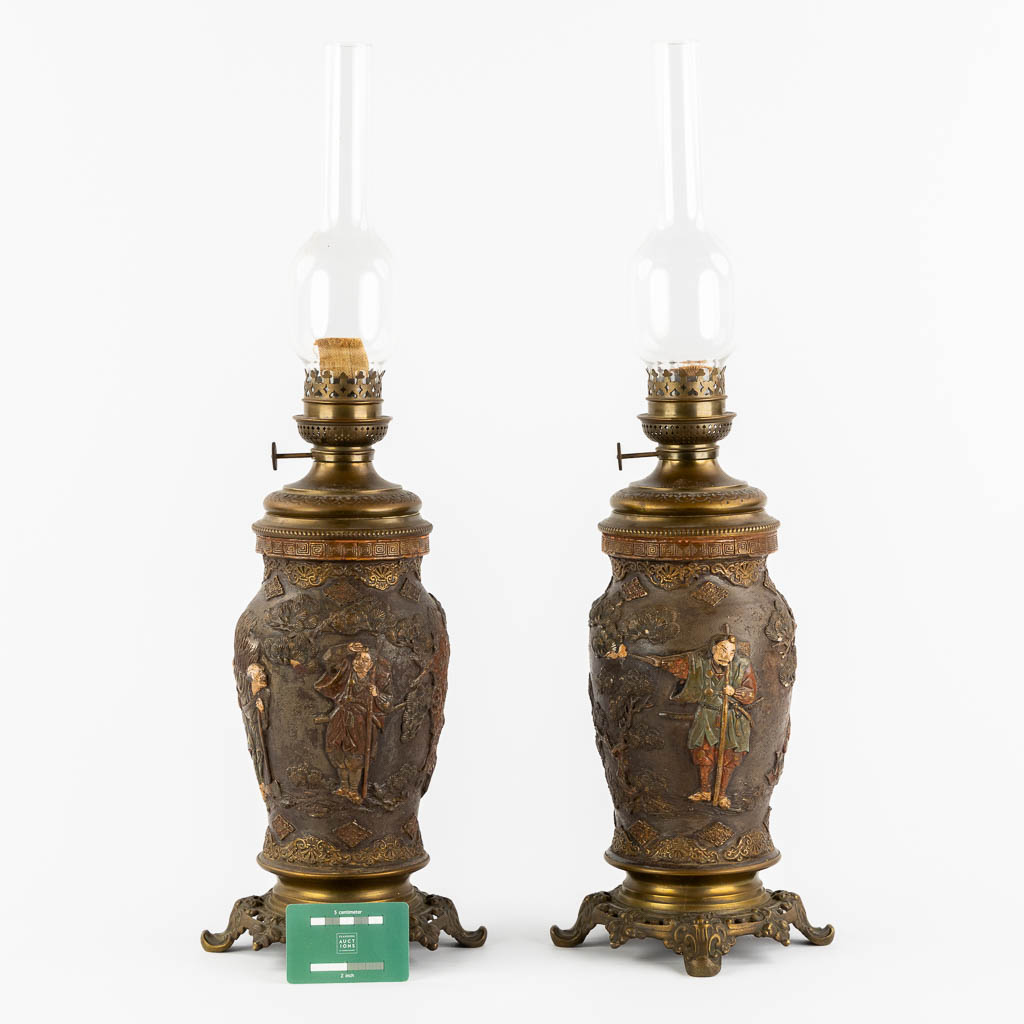 An Oriental pair of oil lamps, terracotta mounted with bronze. Circa 1900. (H:66 x D:18 cm)