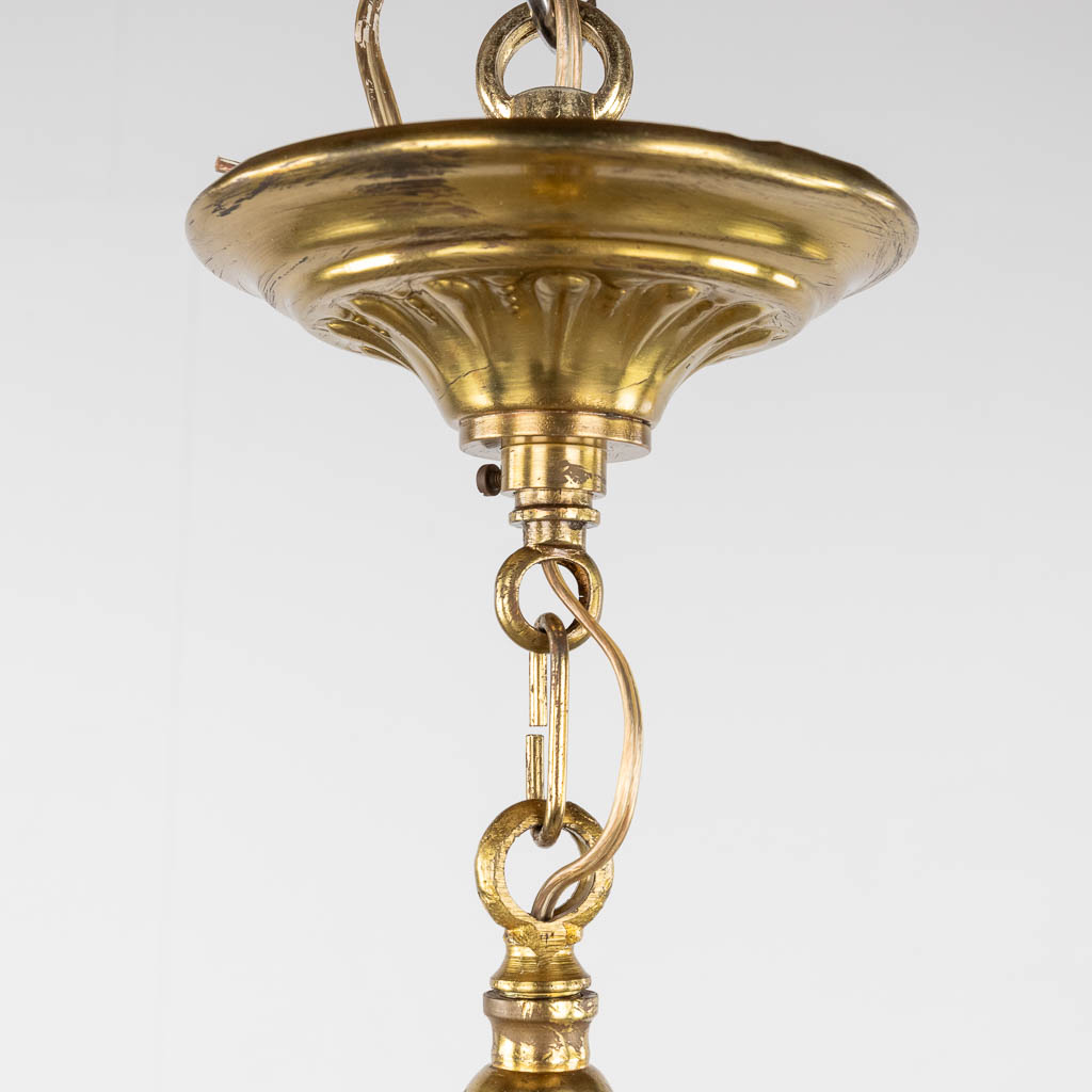 A chandelier, bronze finished with ram