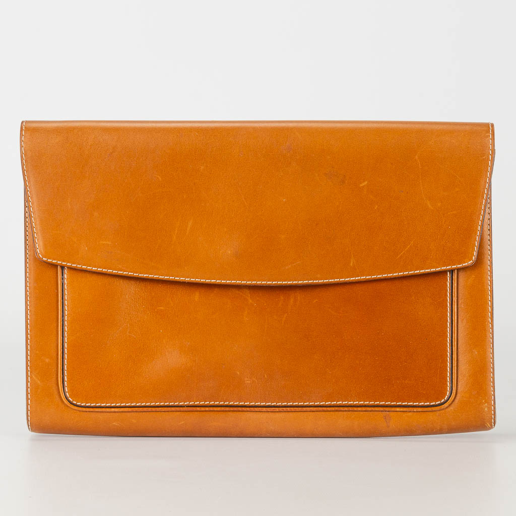 A purse made of brown leather and marked Delvaux.