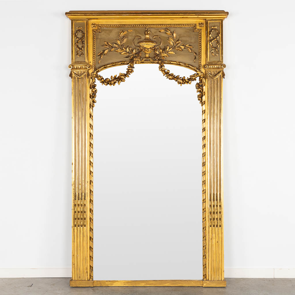 A fine and antique mirror, gilt and sculptured wood in a neoclassical style. 19th C. (W:113 x H:190 cm)