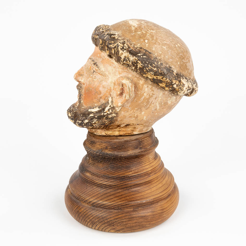 The head of a holy figurine, probably Saint Anthony. Sculptured wood with original polychrome (12,5cm)