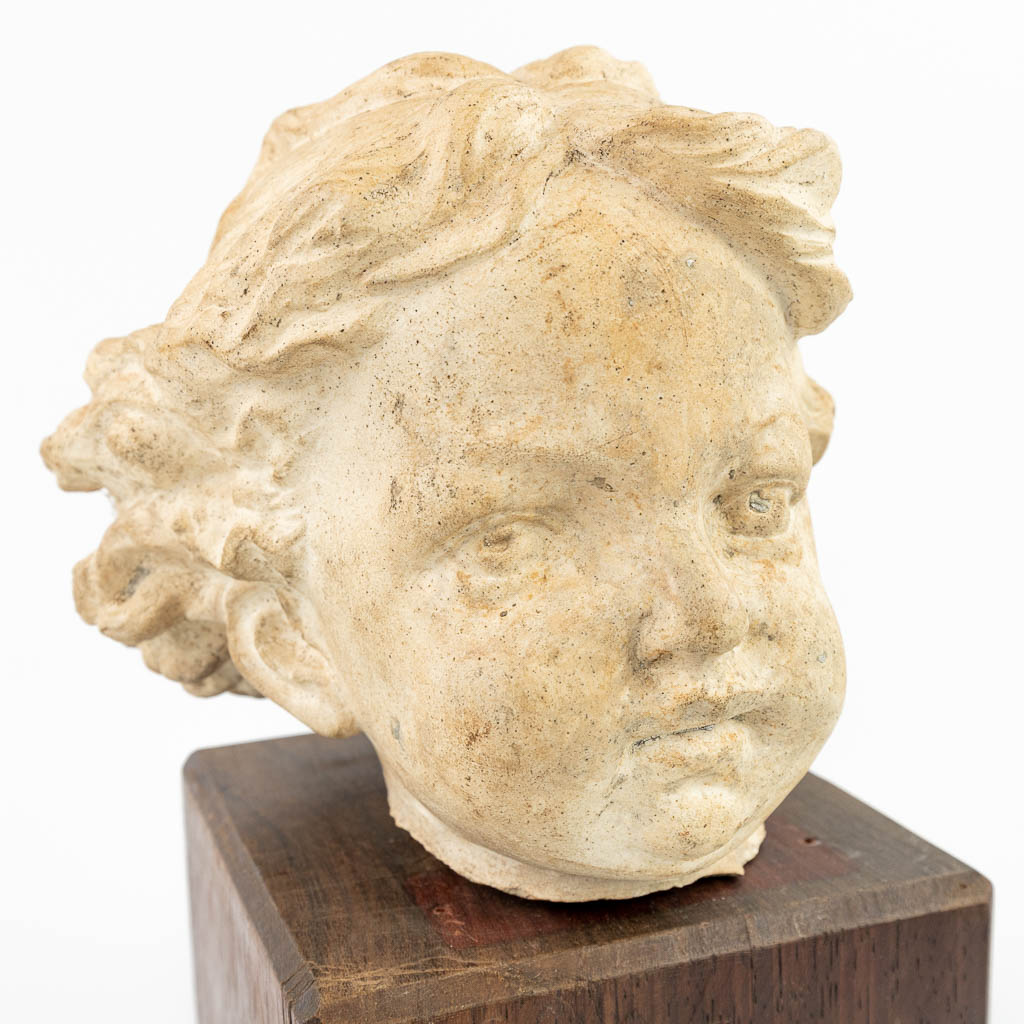 A head of a child made of terracotta. (H:14cm)