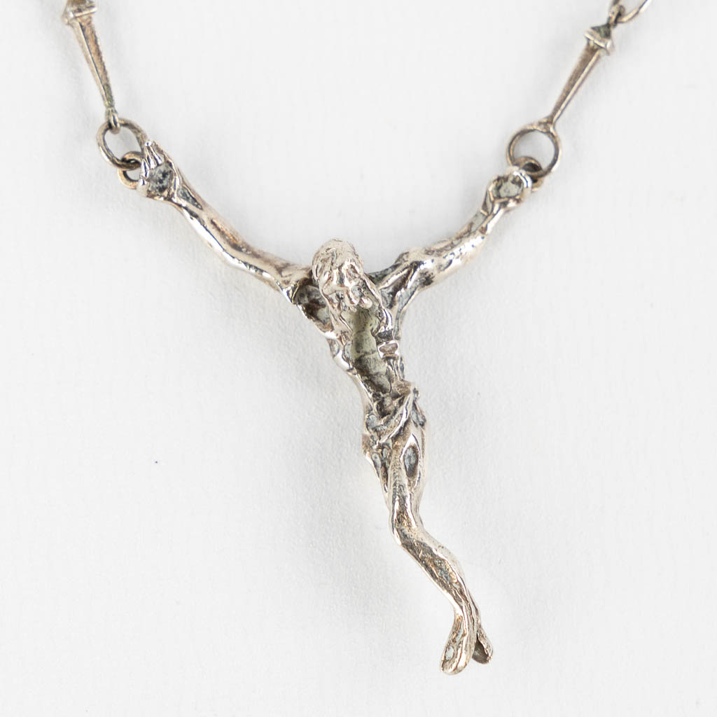 After Salvador DALI (1904-1989) 'Christo' a silver pendant. (L:44 cm)