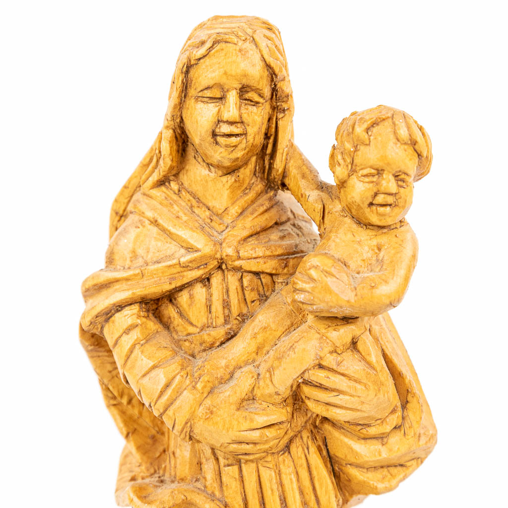 A collection of 3 wood sculptured madonnas with a child. (H:32cm)