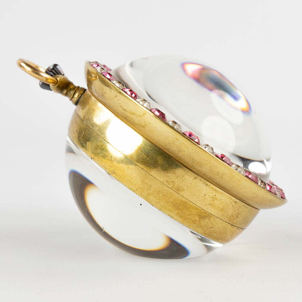 Doxa, a large pocket or table watch in the shape of a ball with an erotic scène and automata. 20th C. (H:9 x D:6 cm)