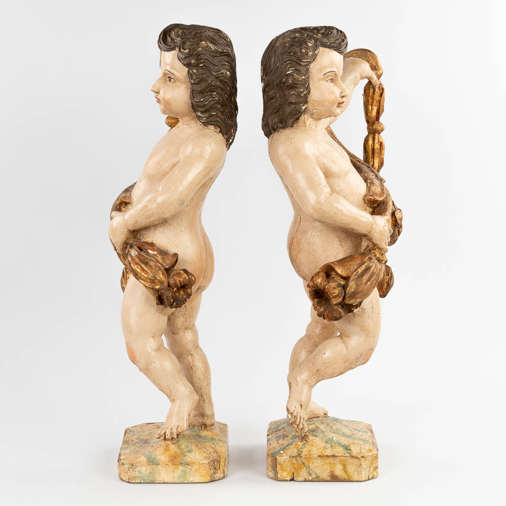 A pair of wood-sculptured angels, polychrome, 18th/19th C. (D:18 x W:34 x H:70 cm)