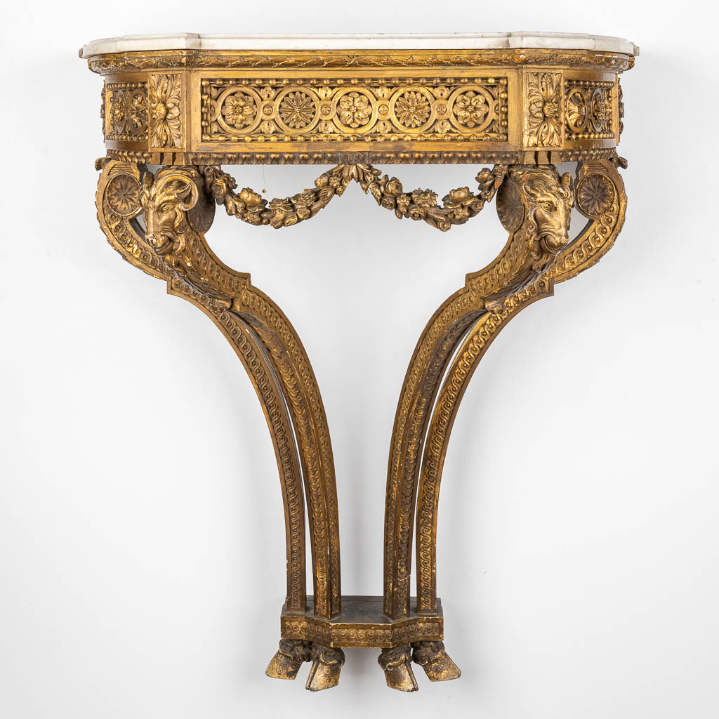 A console table with ram's heads, gilt and sculptured wood and a Carrara marble top. 19th C. (D:41 x W:79 x H:91 cm)